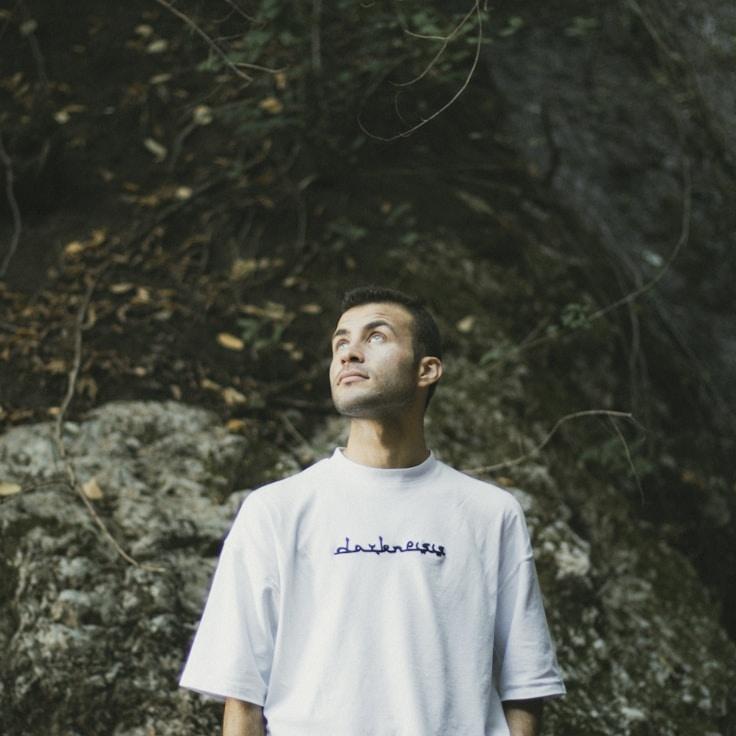 Avery Singh, Lead Design Curator at CalmRidgeForest, reviewing corporate floral arrangements